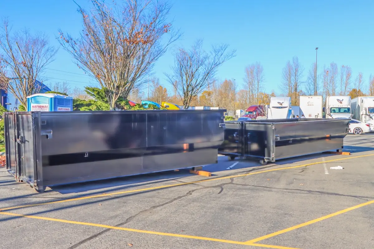 Professional dumpster rental service with roll-off container on residential driveway in Wagoner